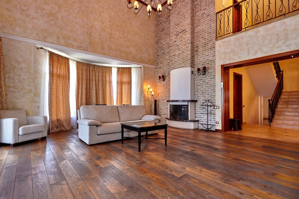 Living room with earth tones and dark hardwood floors.